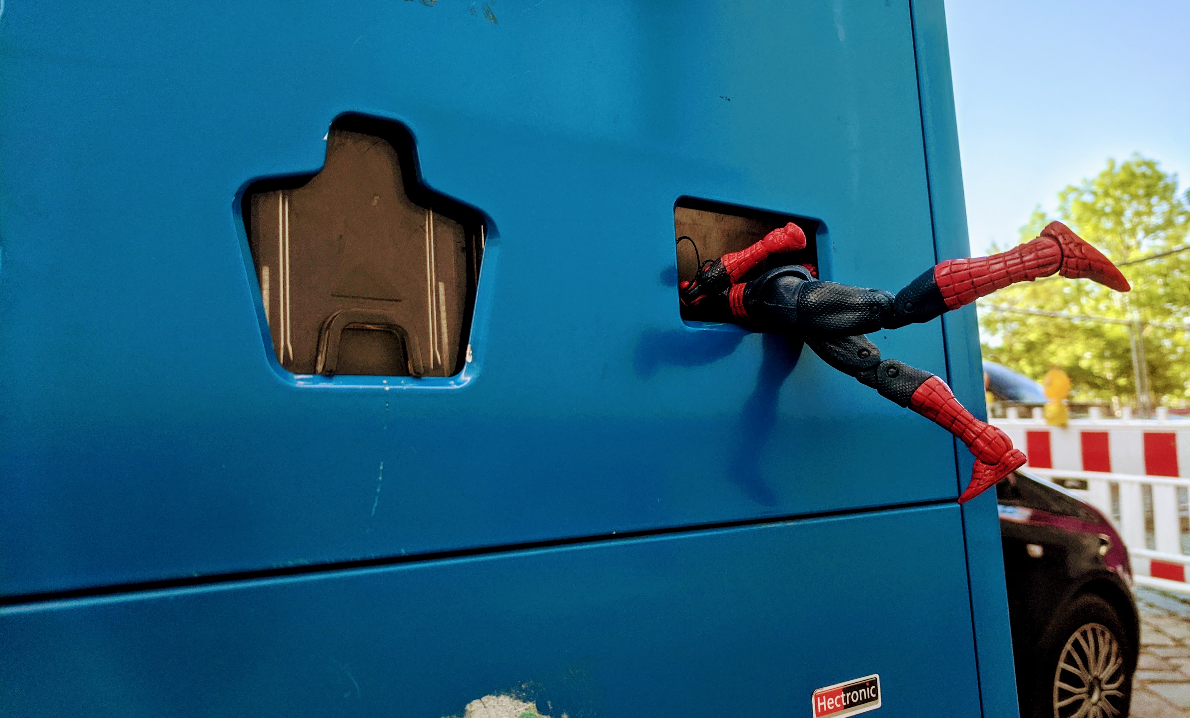 A picture of a Spiderman stuck flailing in a coin return slot. Yes, really.
